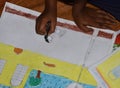 poor Indian primary school kid drawing in a Sit and draw compitition