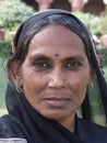 Poor indian woman pose during the short break while she works as sweeper in Agra Fort, India