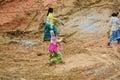 Poor Indian women workers walking through a construction site