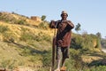 Poor malagasy men cutting timber