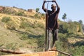 Poor malagasy men cutting timber