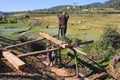 Poor malagasy men cutting timber