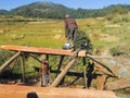 Poor malagasy men cutting timber