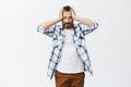 Poor male gambler lost everything he got. Portrait of desperate and miserable gloomy man in checked shirt, holding hands Royalty Free Stock Photo