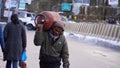 poor man with gas cylinder and going home image