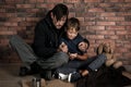 Poor man and his son sitting om floor Royalty Free Stock Photo