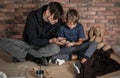 Poor man and his son sitting om floor Royalty Free Stock Photo