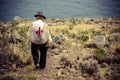 Poor man walking down a cliff, Taquile Island, Titicaca lake, Peru
