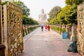 Poor man waiting for tourists near Buddha statue Royalty Free Stock Photo