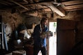 Poor mature man gathering firewood at home, poverty concept. Royalty Free Stock Photo