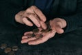 Poor mature woman counting coins at table Royalty Free Stock Photo
