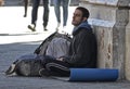 Poor men asks for money in a commercial street in Barcelona Royalty Free Stock Photo