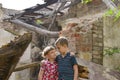 Poor and neschatnye children on the ruins of a burnt house. The brothers suffered a natural disaster.