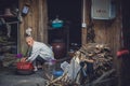 Poor old man doing house chores in China