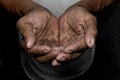 The poor old man`s hands beg you for help. The concept of hunger or poverty. Selective focus. Royalty Free Stock Photo