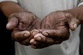 The poor old man`s hands beg you for help. The concept of hunger or poverty. Royalty Free Stock Photo