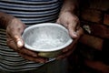 The poor old man`s hands hold an empty bowl. The concept of hunger or poverty. Selective focus. Poverty in retirement.Homeless. Al Royalty Free Stock Photo