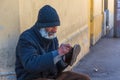 Poor old man shining shoes in the street Royalty Free Stock Photo