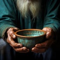 Poor old mans hands with empty bowl, symbolizing hunger and poverty
