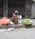 A poor old woman selling corn in the streets