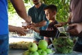 Poor people receiving food from volunteer