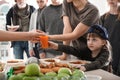 Poor people receiving food from volunteers