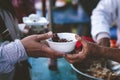 Poor people's hands share free food from volunteers who donate food : concept of feeding, sharing food