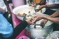 Poor people's hands share free food from volunteers who donate food : concept of feeding, sharing food