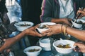 Poor people's hands share free food from volunteers who donate food : concept of feeding, sharing food