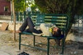 A poor person taking nap on bench Royalty Free Stock Photo