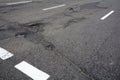 Poor quality of road repair work. Damaged asphalt road, bad road.