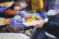 The poor reach out to receive donated food: Homeless people receive free charity food Royalty Free Stock Photo