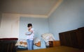 Poor sad small girl in bedroom indoors at home, poverty concept. Royalty Free Stock Photo