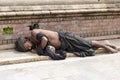 Poor sadhu, holy man sleeping on the street in Pashupatinath Temple, Kathmandu. Nepal Royalty Free Stock Photo