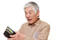 Poor senior Japanese man looking at his own empty wallet Royalty Free Stock Photo