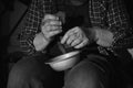 Poor senior man with bowl and bread, closeup