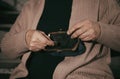 Poor senior woman with empty wallet and coin indoors