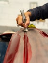 Poor Spaniard fixes the bumper of his car with a hammer. Madrid