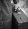 poor traveler with worn leather suitcase with black and white effect Royalty Free Stock Photo