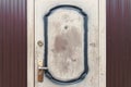 Poor vintage scratched door with knob outdoor entrance background furniture