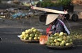 A poor woman in busy market in Vietnam