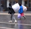 Poor women dragging bags in motion blur
