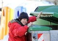 Poor young boy tries to eat into the waste box