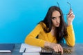 A poor young girl counts money at home at her desk, hoping that she will have enough for all expenses Royalty Free Stock Photo