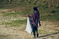 Young village lady is carrying a bag stock photograph