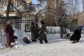 Russia, Novosibirsk, February 23, 2019: poorly dressed unemployed women pensioners beggars begging and money near the Church alms Royalty Free Stock Photo