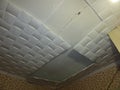 Poorly glued tile on the ceiling