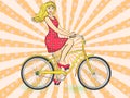 Pop art background with sun rays. Young beauty woman ride bicycle retro raster. Comic book style imitation.