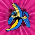 Pop art banana on a pink retro background with radial stripes. Cartoon comic style half peeled banana vector illustration Royalty Free Stock Photo