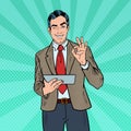 Pop Art Businessman with Tablet Gesturing OK and Winking Royalty Free Stock Photo